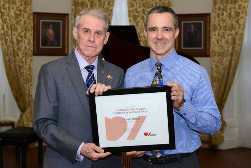 Kevin Stairs, right, of Bras d’Or, is shown receiving his Heart and Stroke Foundation outstanding volunteer award from J.J. Grant, Lieutenant Governor of Nova Scotia. Stairs received the award for his work with the foundation’s big bike fundraiser in Sydney Mines.