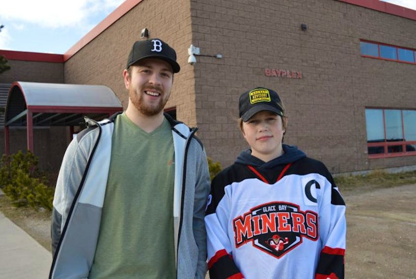 Glace Bay Miners peewee ‘A’ coach Kenzie Wadden and team captain Brady Doucette are shown in front of the Bayplex in Glace Bay. The team is a frontrunner to win the 2017 Good Deeds Cup, a contest run by Chevrolet.