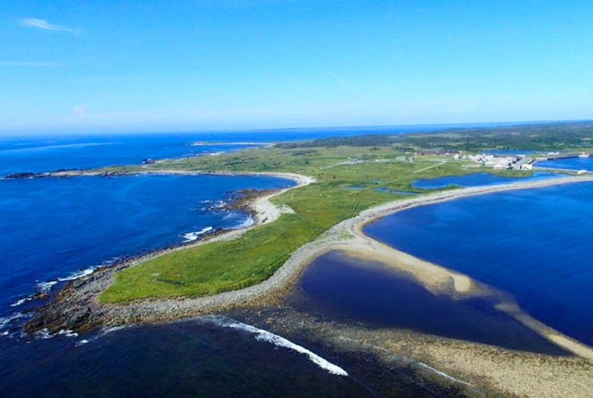 This aerial view shows Rochefort Point, in the foreground, with the reconstructed quarter of the Fortress of Louisbourg visible in the back right. The point is the site of a historic graveyard that is in jeopardy due to coastal erosion. Parks Canada is teaming with the University of New Brunswick’s Department of Anthropology this summer to document, protect and preserve the 18th century burial ground.