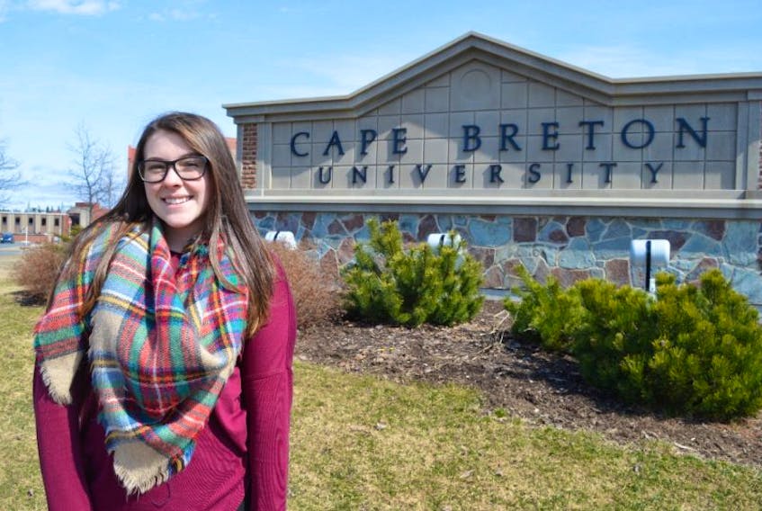 Brianna Desveaux of New Victoria stands in front of Cape Breton University. The 20-year-old, currently in the third year of her bachelor of science degree studies at the school, was recently awarded a scholarship to conduct research in Germany.