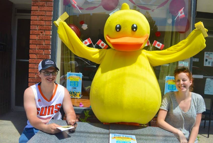 Bay Days mascot Renwick sells tickets for the annual duck race outside the Bay Days office at 121 Commercial St., Glace Bay on Tuesday with Markus Mischiek and Sara Carabin. Bay Days take place July 14-16.