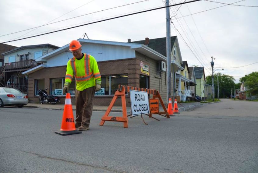 Greg Shephard of Northern Contracting sets up a detour on Townsend Street in Sydney on Wednesday morning. 