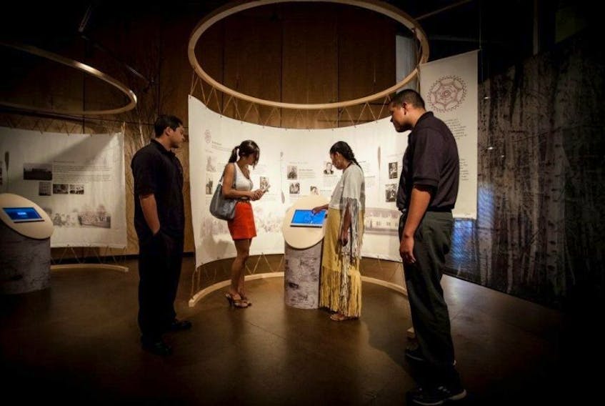 A tour guide goes over Mi’kmaq history with visitors at Membertou Heritage Park.