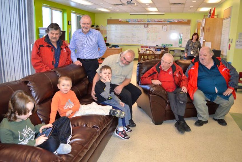 Students in the Learning Centre at the New Waterford School in River Ryan, from left, William Fraser, Conner Aucoin and Myles Martin, try out the centre’s new furniture purchased by the New Waterford Kinsmen Club while visiting with Kinsmen members Joe Curry, vice-president, Angus Gillis, president, Andrew Digero, treasurer, Gary Cummings, teacher Greg Wareham, president of the K-40 Club.