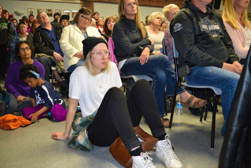 Ashley McKenzie of Sydney, formerly of New Waterford, listens during the town hall meeting organized by the A Town That Cares group at the New Waterford fire hall Tuesday night. More than 300 people packed into the fire hall, determined to see a solution to the lack of resources for mental health and drug addictions in the Cape Breton Regional Municipality.
