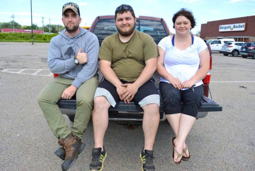 Dylan Yates, left, of Glace Bay, founder of the ‘Stop Illegal Dumping in the CBRM’ group on Facebook, sits with Joseph Pushie, Glace Bay, and Tanya Pushie, Birch Grove, as they prepare for a cleanup of Sand Lake Road today at 10 a.m.