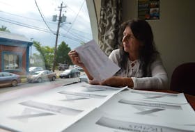 Christine Porter, executive director of the Ally Centre in Sydney, looks at a list of names of people who have overdosed in Cape Breton. Their names are being put on placard for display during the upcoming International Overdose Awareness Day event at Wentworth Park on Aug. 31.