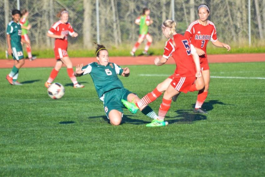 Chantal Caron, left, of the Cape Breton University Capers slides into Candace Conrad of the Acadia University Axewomen during a regular season AUS soccer game at the Cape Breton Health Recreation Complex on Friday night. The Capers shut out the Axewomen 1–0.