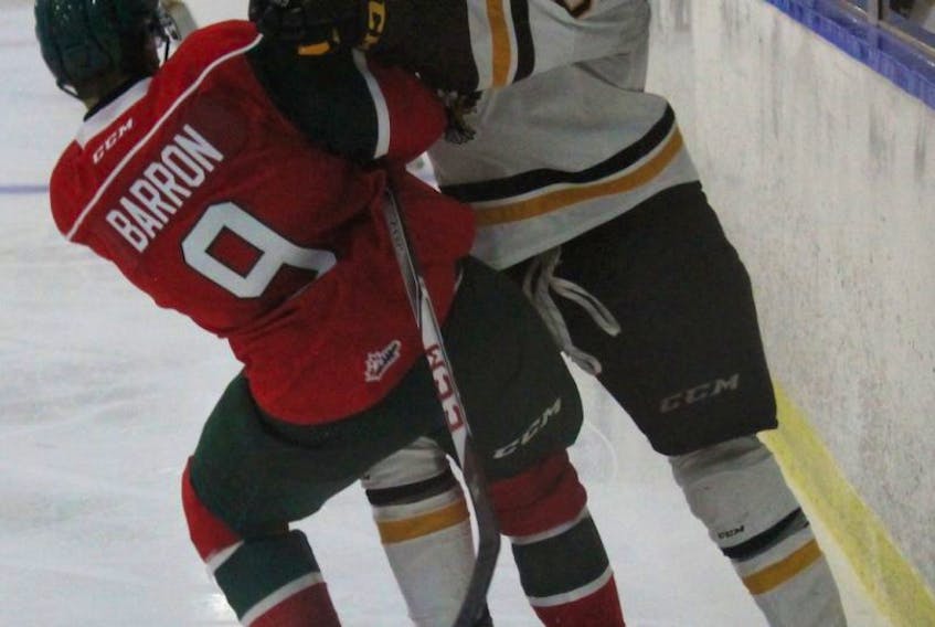 Justin Barron of the Halifax Mooseheads, left, takes a hit from Alexis Sansfaçon of the Cape Breton Screaming Eagles during Quebec Major Junior Hockey League exhibition action Wednesday in Lantz, N.S. The teams meet again tonight at the Membertou Sport and Wellness Centre at 7 p.m.
