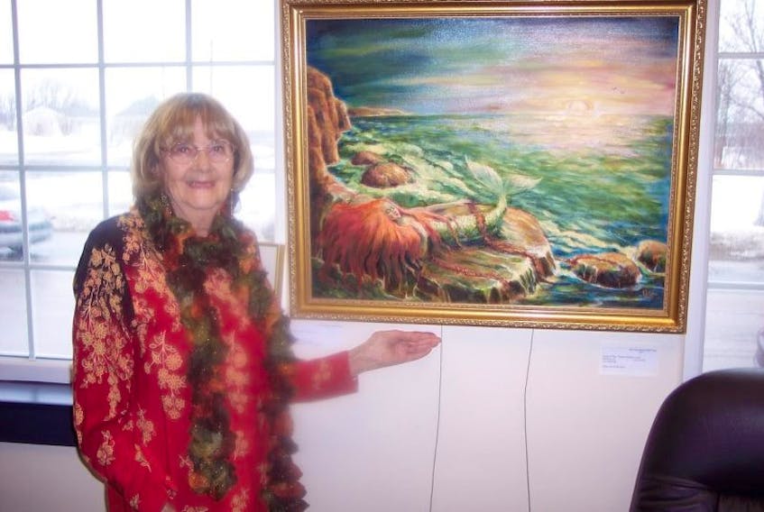 Jeanne Gyorfi-West, 87, the featured artist at the Main Street Art Gallery in the New Waterford Credit Union, shows a piece of her work. Gyorfi-West, who has about 30 pieces in the show, says this will be her last solo show.