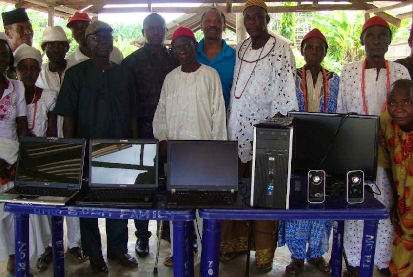 Dr. Princely Ifinedo delivered computers to community members associated with Obodeti Secondary Commercial School in Delta State in Nigeria. Pictured, starting sixth from left: Mr. Chinedu (wearing glasses), R. Ajameh, Mr. Taiye Ozah, Chief Joseph Azagba, Dr. Princely Ifinedo and High Chief Jacob Egbuwe.