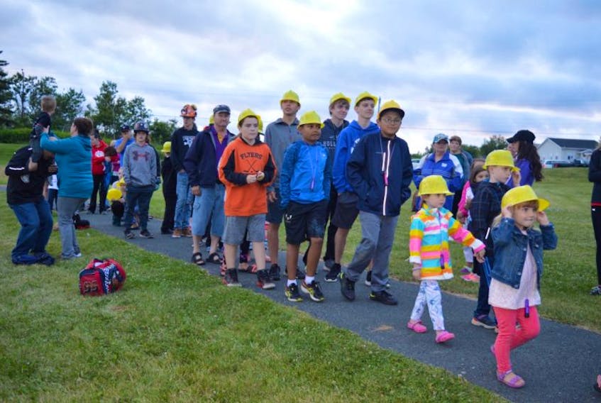 Dozens of children wore plastic “miners’” hats, shone lights and laid roses at the monument in Colliery Lands Park on Tuesday. The children were part of the 100-year ceremony to remember the disaster in No. 12 Colliery in New Waterford that took the lives of 65 miners.