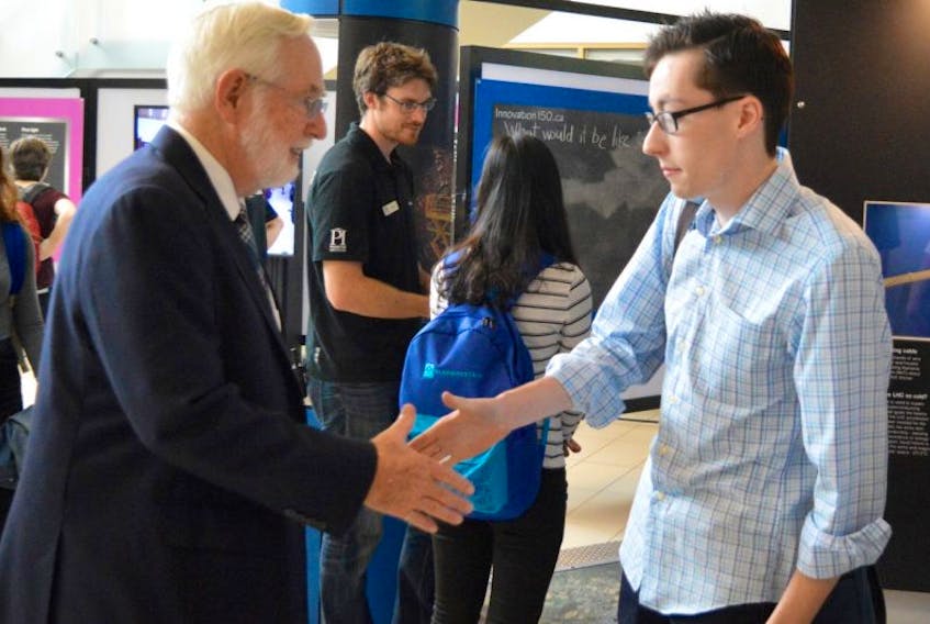 Breton Education Centre Grade12 student Joshua Cameron, right, said it was a pleasure to meet Sydney native and astrophysicist Art McDonald, who was awarded a 2015 Nobel Prize in Physics for his work on neutrino oscillation, at the Power of Ideas science exhibition on Monday at Cape Breton University.