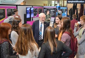 Dr. Art McDonald, a Sydney native who won the 2015 Nobel Prize in Physics, holds court with a group of high school students from New Waterford’s Breton Education Centre on Monday at a scientific exhibition at Cape Breton University. McDonald also gave a lecture to students at Sydney Academy, the high school he graduated from in 1960.