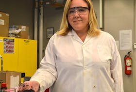 Stephanie MacQuarrie, an associate professor in organic chemistry at Cape Breton University, holds some Breton Organic Charcoals biochar in her lab.