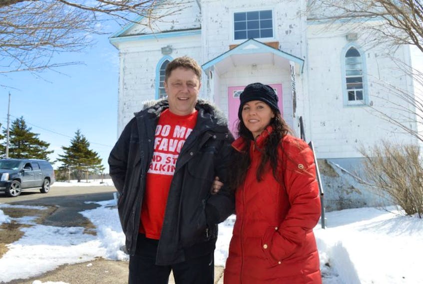 Corrina Kelly and her husband, Mike Kelly, of New Waterford, stand in front of the former St. James Catholic Church in Gardiner Mines which they have purchased. Corrina said after living away from Cape Breton for 20 years they moved home to retire and plans were to move into the church and make it their home. However, she said, they made extensive renovations inside and it now houses the Premier Cheer Allstars group in the upstairs with plans still to be determined for the lower floor.