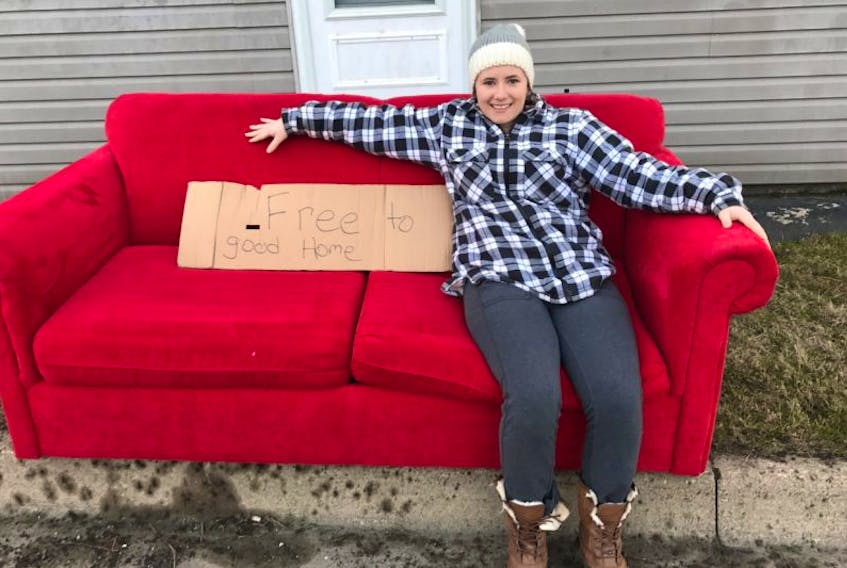 Mira Beaton of Dominion sits on a couch put curbside for heavy garbage pickup on Mitchell Avenue in Dominion. The couch had a sign on it saying ‘free to good home’ and that’s just where it went.