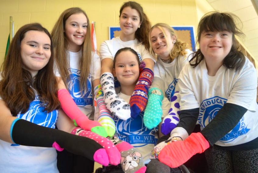 Members of the Oceanview Education Centre Me To We group in Glace Bay display some of the silly socks that will be sold. Front, Hope McInnis and from left, Rhiannon Hickey, LeeLee MacNeil, Meghan McIntyre, Rebecca MacMullin and Faith MacPherson. The group is supporting Faith MacPherson who has Down syndrome by selling silly socks to bring awareness to the syndrome.