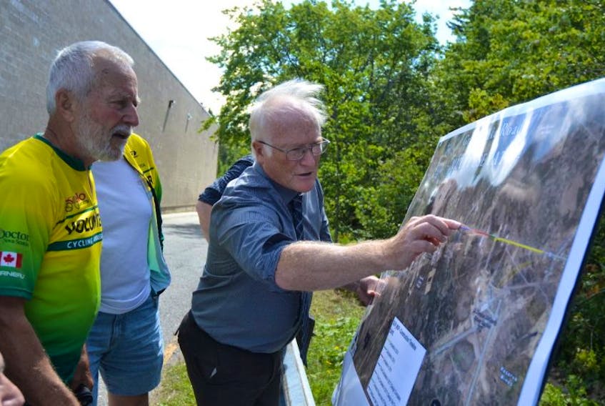 CBRM senior planner Rick McCready, right, explains to Jacques Coté of Velo Cape Breton plans to complete the Grand Lake Road multi-use trail following an announcement Monday of $60,000 in provincial money to support the project.