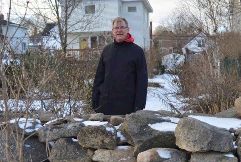 Tom McNeil stands in the backyard of his St. Peter’s Road home in Sydney that was deemed uninhabitable after the Thanksgiving Day flood. McNeil and his wife have invested 15 years of love and labour into their garden, which includes an English-style stone wall that he built by hand with rocks from central Cape Breton.