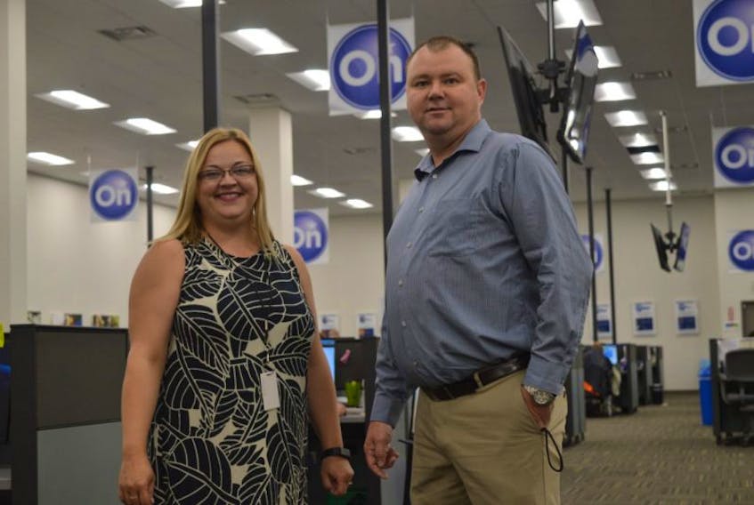 Servicom program manager Cathy Harris stands with director Todd Riley in their Sydney office on Tuesday. The call centre has been open 24 hours a day since Friday, taking calls from people affected by hurricane Harvey in Texas.