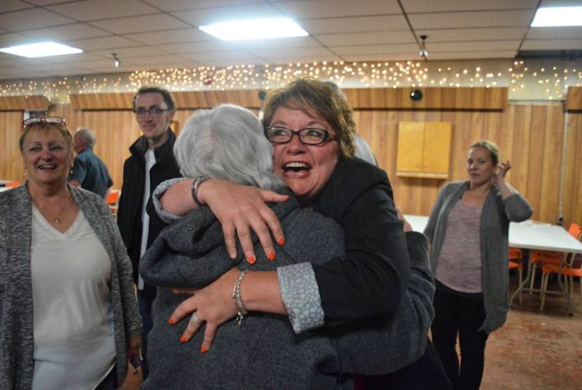Cape Breton Centre NDP candidate hugs a supporter following her upset win over Liberal incumbent Dave Wilton in Tuesday's provincial election.