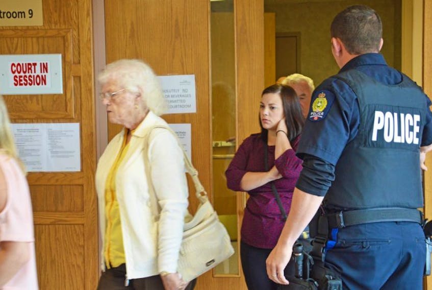 Deanna Marie Jessome, right, walks out of a Sydney courtroom with her grandparents after hearing that convicted murderer, Thomas Ted Barrett, will not stand trial in the 2012 death of her sister, Laura Jessome.