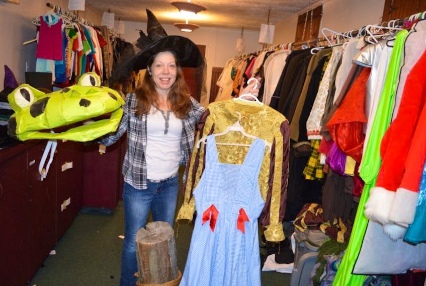 Actress Angela Duhamel of Glace Bay holds up a frog head used in a production of “Glooscap and the Mighty Frog” as well as costumes from musicals such as “The Wizard of Oz” and “Les Miserables” which can be found in the costume room at the Savoy Theatre in Glace Bay. The Savoy is launching its 90 for 90 fundraising campaign today.