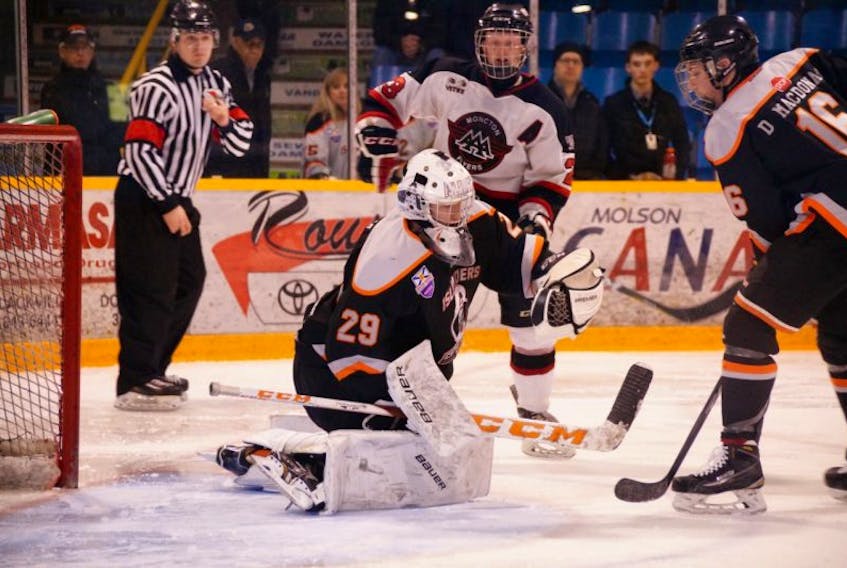 Colten Ellis of the Cape Breton West Islanders makes a glove save during a game against the Moncton Flyers at the Atlantic major midget hockey championships on Friday. The Islanders won the game 5-1.