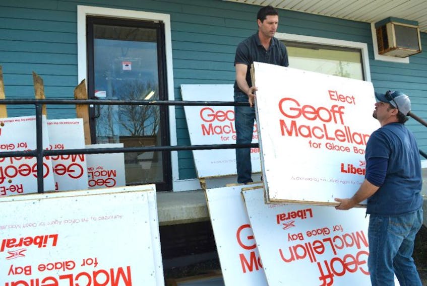 Glace Bay MLA Geoff MacLellan, left, gets help from Steven Ogley, a member of his campaign team, while packing up election signs at his headquarters on McKeen Street in Glace Bay on Wednesday. MacLellan said he’s happy to be back as Glace Bay MLA, noting it was a tight race where the public sent a clear message that the Liberal government is listening to and now he’s anxious to work on some of those issues, including health care.