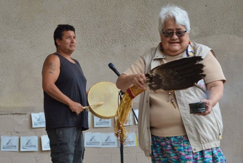 Katy MacEwan, an elder from Membertou First Nation, performed a smudging ceremony at the start of a recent Overdose Awareness Day event, while one of the Membertou drummers performed the honour song.
