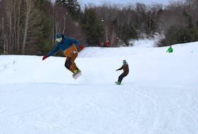 A snowboarder catches some air as Ski Ben Eoin marked opening day on Tuesday.