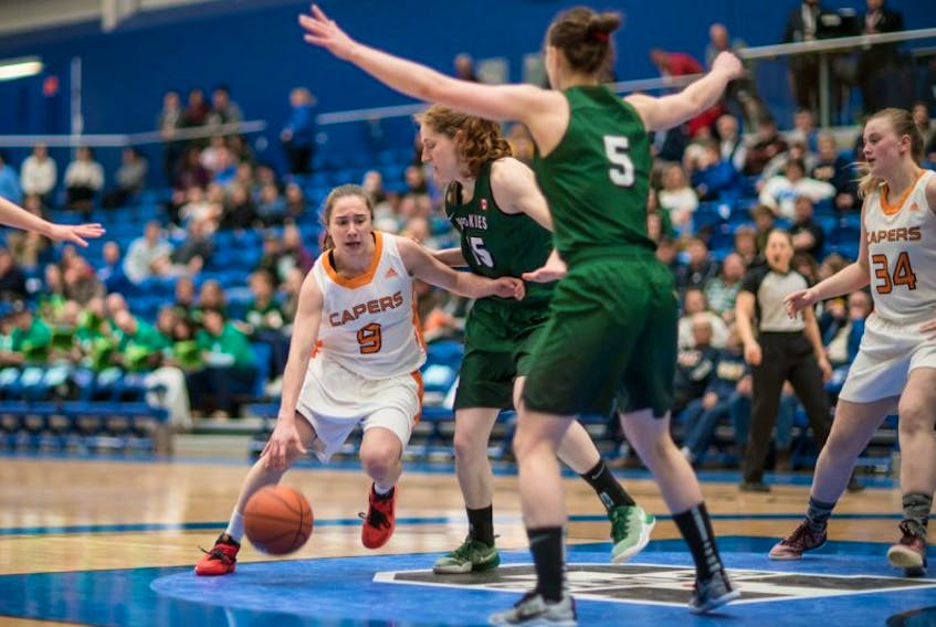 Timea Peter, left, of the Cape Breton University Capers drives the lane during U Sports Women’s Final 8 action against the University of Saskatchewan in Victoria, B.C., on Friday. Saskatchewan won the game 65-51.