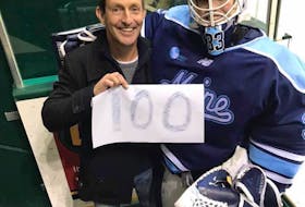 Carly Jackson and her father, Rob, share a moment after she played in her 100th NCAA game with the University of Maine Black Bears in November. Contributed