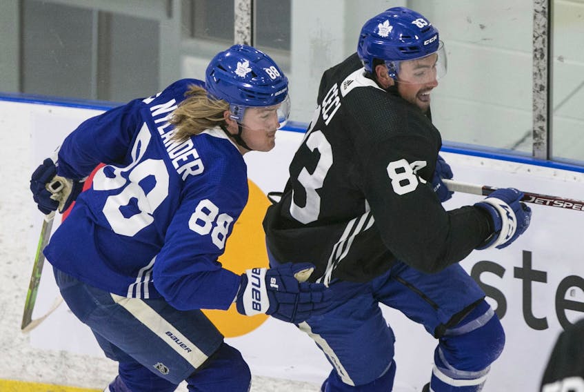 William Nylander and Cody Ceci (left) go after a lose puck at Maple Leafs training camp.