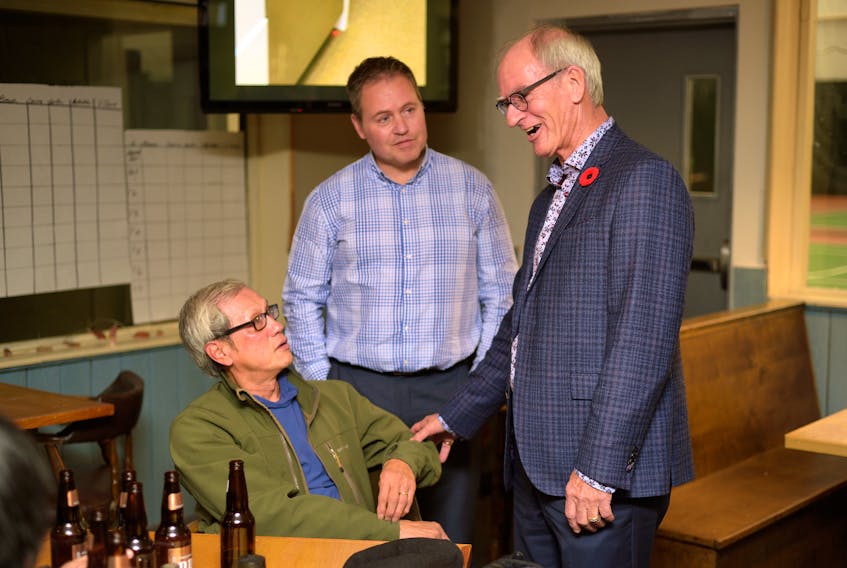 Cecil Villard chats with supporters Tunglam Tran, left, and Marcel Arsenault at his headquarters in Charlottetown on Monday, Nov. 5, 2018.