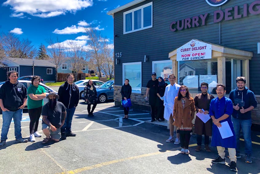The people who contributed to delivering 150 meals on Sunday stand physically distant outside Curry Delight in Mount Pearl. From left to right: Volunteers Declan Hai and Finley Hai; Organizer Hasan Hai; Volunteers Kadin Hai, Alisa Cutler and Tanisha Furlong; Curry Delight co-owners Muhammad Nasir and Afiya Altaf; Members of the NL Eats team: Shourov Islam, Mehnaz Tabassum, Saif Ahmed, Adib Rahman and Mehdi Khan. -JUANITA MERCER/THE TELEGRAM