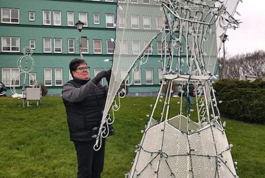 Frances MacDougall, Chairperson, Board of Directors is pictured here putting some final touches to the holiday structures on the lawn of the Northside General. CONTRIBUTED