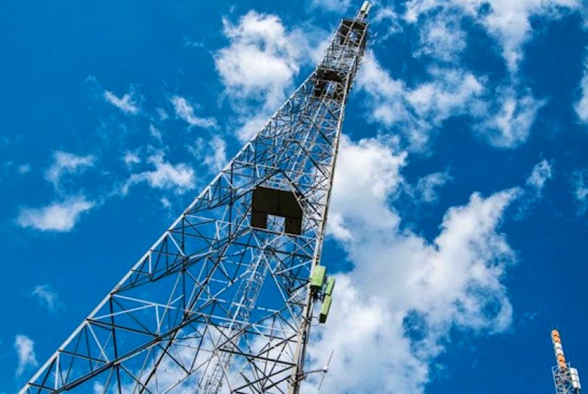 Cellular towers stretch into blue sky in this stock image.