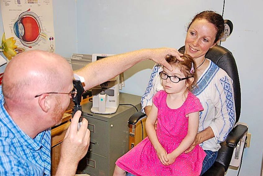 ['Orthopist Lennie Digout examines four-year-old Vaeda Zo Matheson as her mother Lorrie Jollimore looks on. Jollimore has pursued a variety of treatments to best help in the development of her daughter, who was diagnosed with Cerebral Palsy three years ago.']