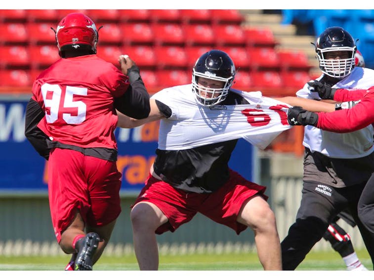 The Calgary Stampeders' Shane Bergman (middle) takes part in practice at McMahon Stadium in this photo from June 2015. File photo by Stuart Dryden/Postmedia.