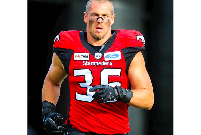 Cory Greenwood of the Calgary Stampeders runs onto the field during player introductions before facing the Toronto Argonauts in CFL football on Thursday, July 18, 2019. Al Charest/Postmedia