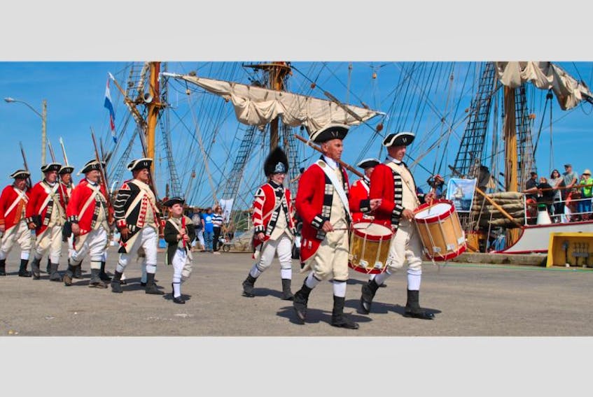 Loyalist reenactors march past the tall ship Europa during the welcoming ceremonies for the vessels at the Shelburne Marine Terminal on Aug. 14.