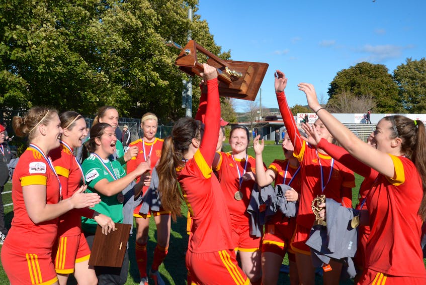 Holy Cross women’s soccer team celebrate with the Breen’s Jubilee Trophy championship hardware after beating Feildians 5-0 in the league final Monday at King George V Park. KEITH GOSSE/THE TELEGRAM 