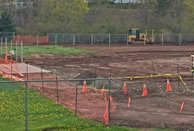 Workers constructing the accessible ballfield beside Dr. J.H. Gillis Regional High School, May 27.