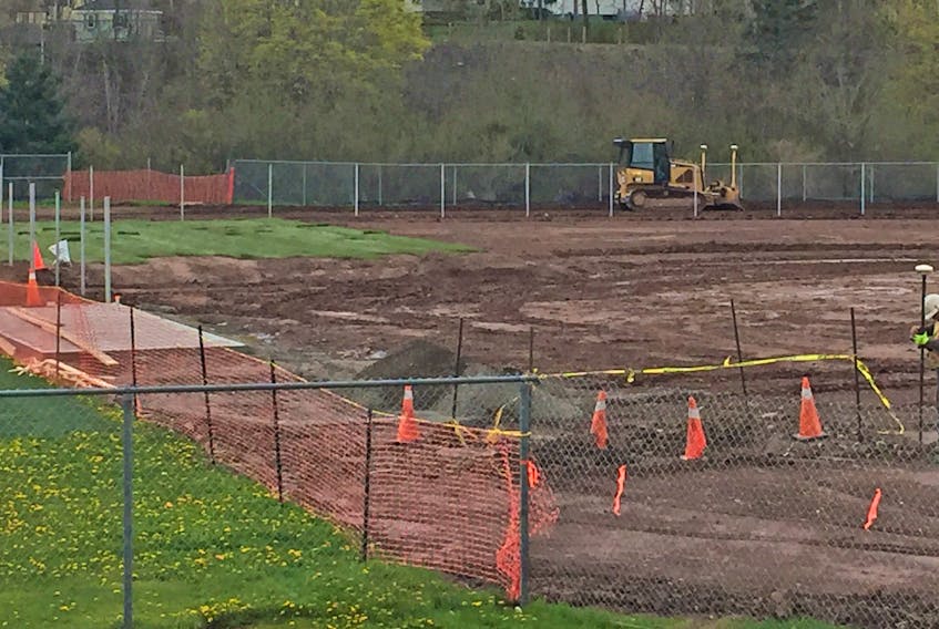 Workers constructing the accessible ballfield beside Dr. J.H. Gillis Regional High School, May 27.