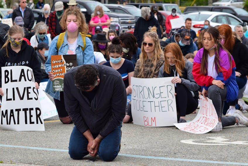 People take a knee to honour George Floyd during a Black Lives Matter unity march  in Shelburne on June 7 in a show of support against systemic racism. KATHY JOHNSON