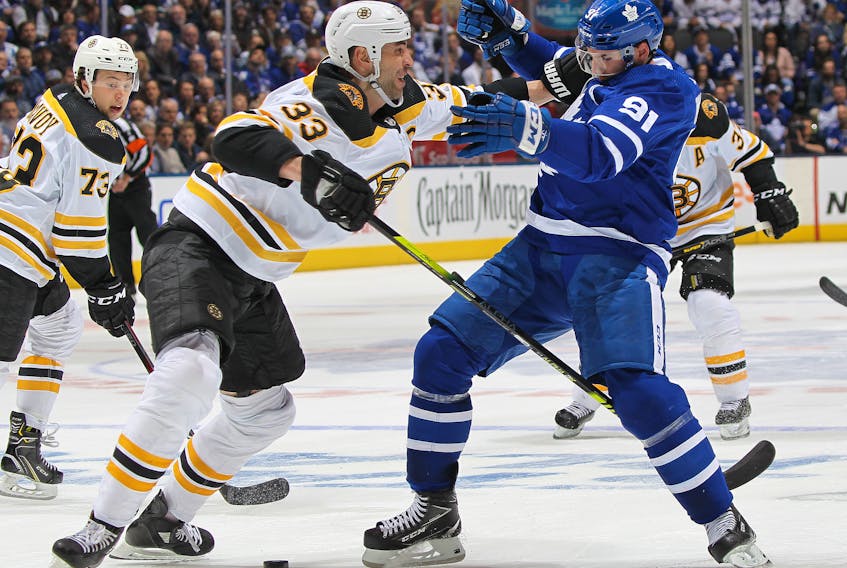 Zdeno Chara (left) of the Boston Bruins shoves Toronto Maple Leafs captain John Tavares during the playoffs last season. (Claus Andersen/Getty Images)