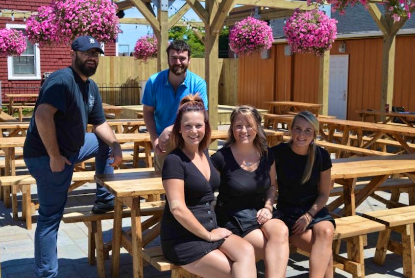 <p>Staff at Charlottetown’s first beer garden were busy on Wednesday getting ready for the grand opening today. Sitting, from left, are Meredith Hines, Karen Brown and Kate Dalziel. Standing are co-owner Steve Barber, left, and Luke Kenny, manager.</p>
<p>&nbsp;</p>