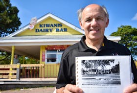 Basil Hambly holds an undated picture of the Kiwanis Dairy Bar. This summer marks the 65th anniversary of the Kiwanis Club operating the bar.